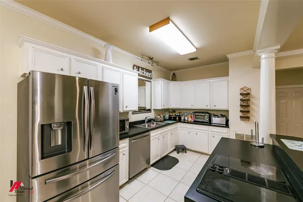 a kitchen with granite countertop a sink appliances and cabinets