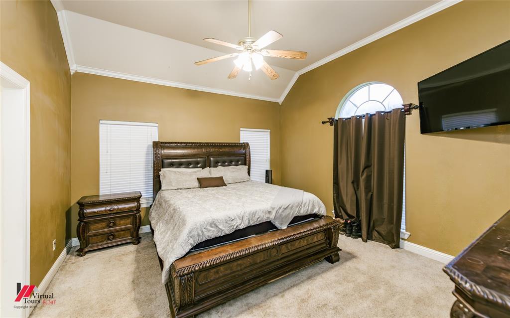 266 Stark Road Stonewall, LA 71078 - Photo 18 of 39 a bedroom with a bed and a flat screen tv