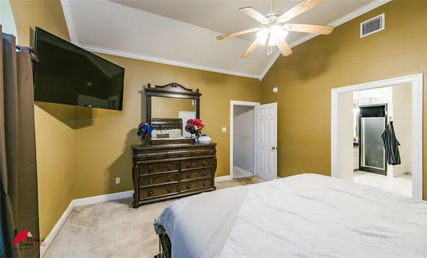 a bedroom with a bed and a flat screen tv