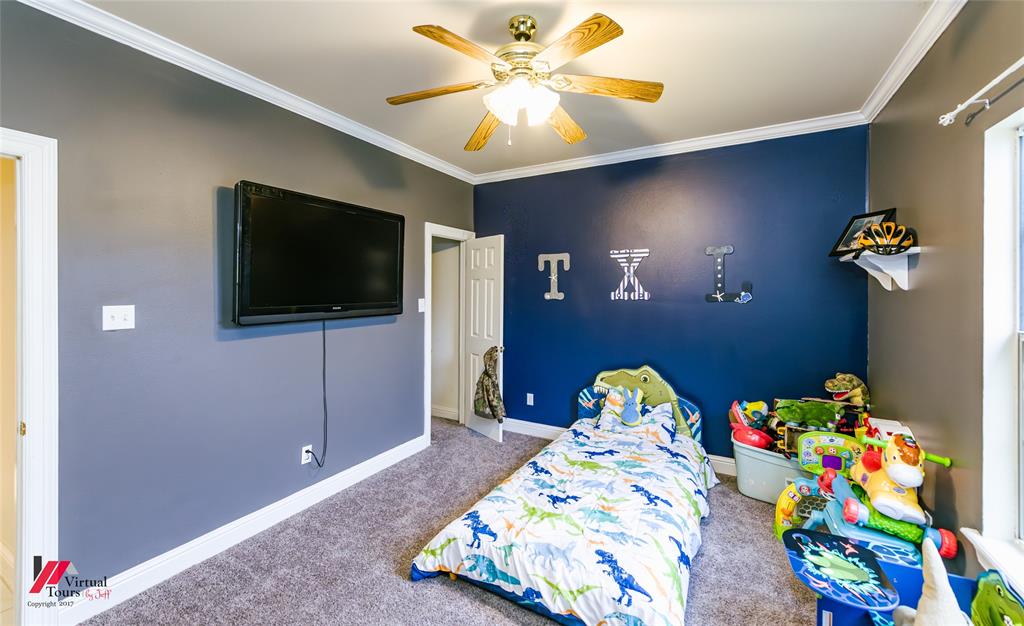 266 Stark Road Stonewall, LA 71078 - Photo 25 of 39 a bedroom with a bed and a chandelier