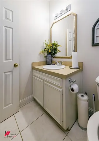 a bathroom with a sink toilet and mirror