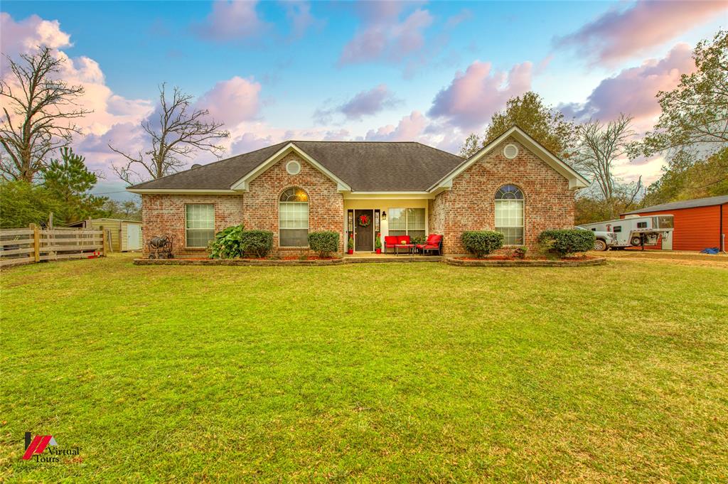 266 Stark Road Stonewall, LA 71078 - Photo 3 of 39 a front view of house with yard and green space