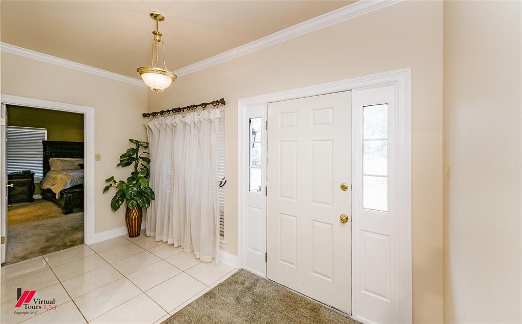 266 Stark Road Stonewall, LA 71078 - Photo 32 of 39 a view of a hallway to a livingroom with furniture and front door
