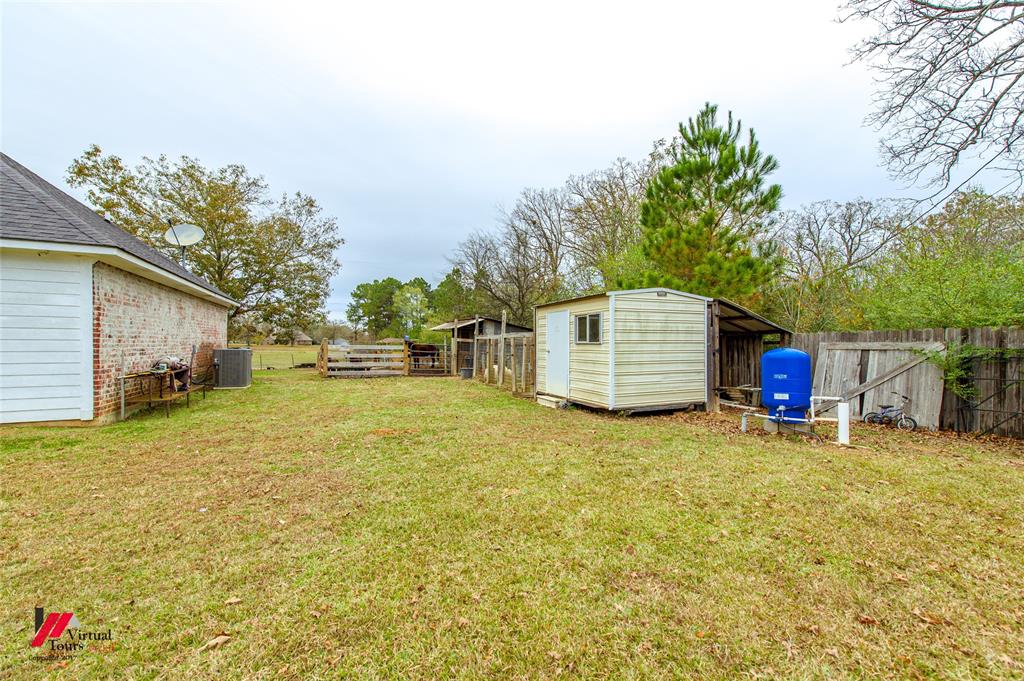266 Stark Road Stonewall, LA 71078 - Photo 37 of 39 a view of a house with a yard and garage