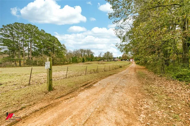 a view of a yard with wooden fence