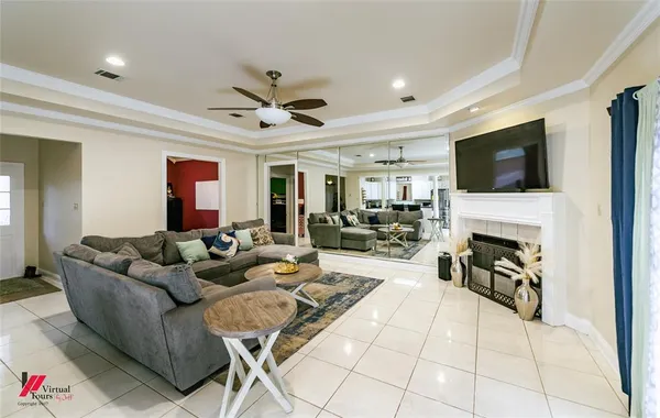 a living room with furniture a fireplace and a flat screen tv