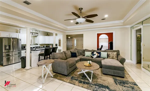 a living room with furniture and kitchen view
