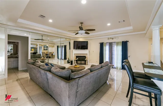 a living room with fireplace furniture and a flat screen tv