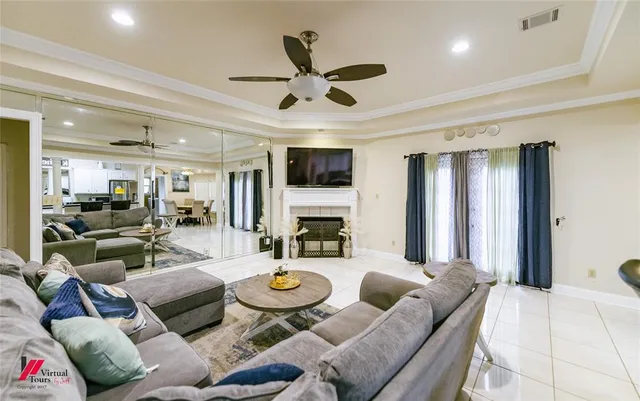 a living room with furniture kitchen view and a large window