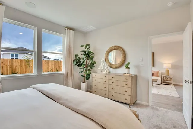 a bedroom with a bed and a dresser