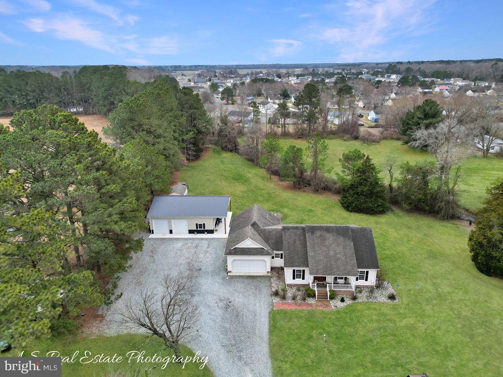 an aerial view of a house with a garden and lake view