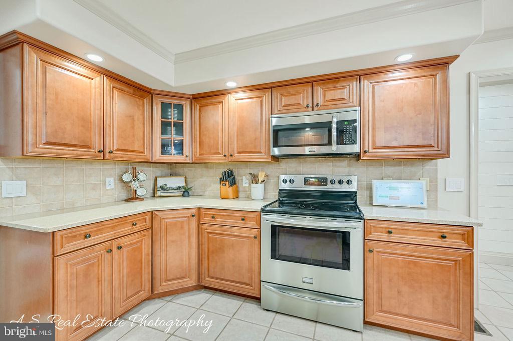 30019 Mt Vernon Road Princess Anne, MD 21853 - Photo 12 of 28 a kitchen with granite countertop a stove top oven microwave and cabinets