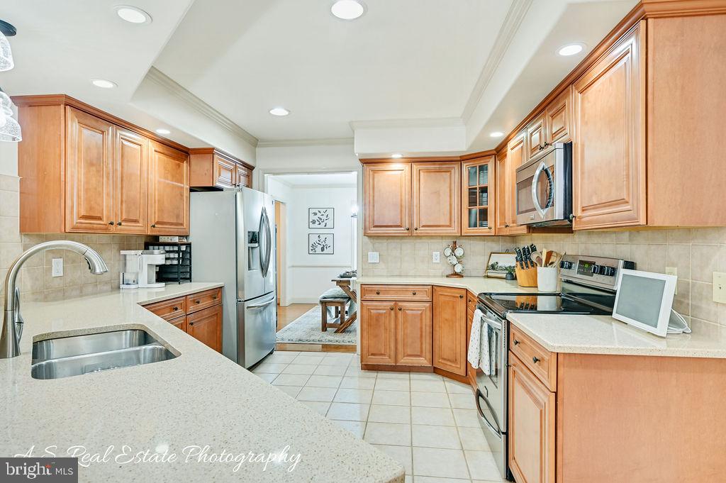 30019 Mt Vernon Road Princess Anne, MD 21853 - Photo 13 of 28 a kitchen with stainless steel appliances granite countertop a sink stove refrigerator and cabinets