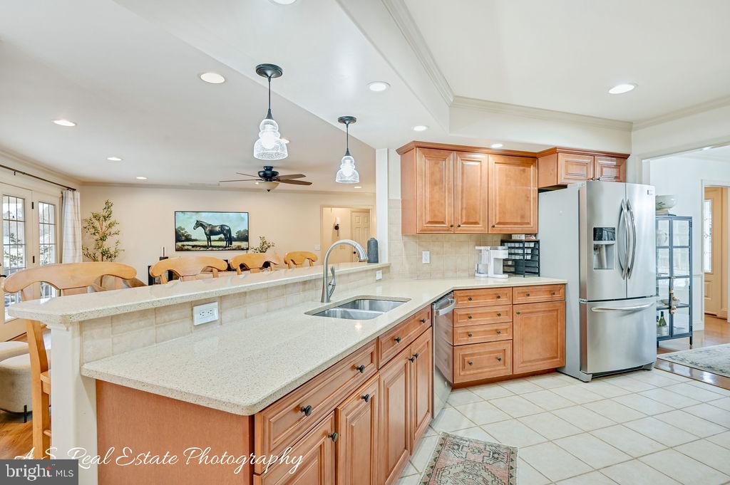 30019 Mt Vernon Road Princess Anne, MD 21853 - Photo 14 of 28 a kitchen that has a lot of cabinets a sink and a refrigerator