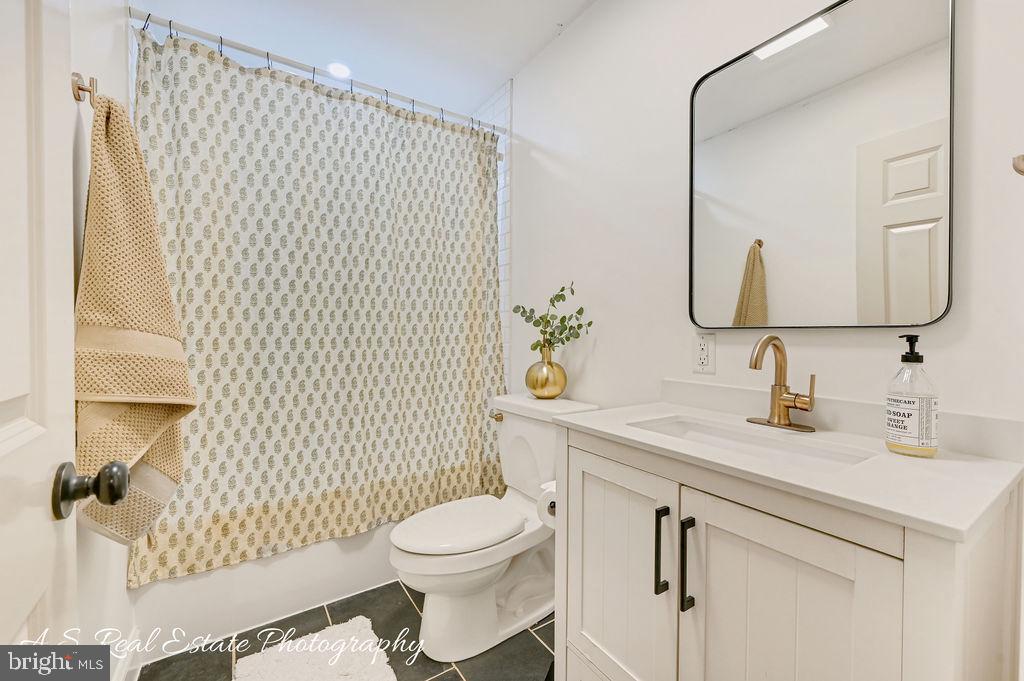 30019 Mt Vernon Road Princess Anne, MD 21853 - Photo 21 of 28 a bathroom with a granite countertop sink mirror vanity and toilet