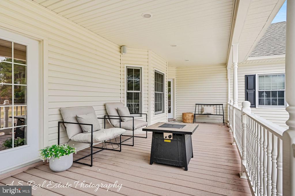 30019 Mt Vernon Road Princess Anne, MD 21853 - Photo 24 of 28 a balcony with furniture and wooden floor