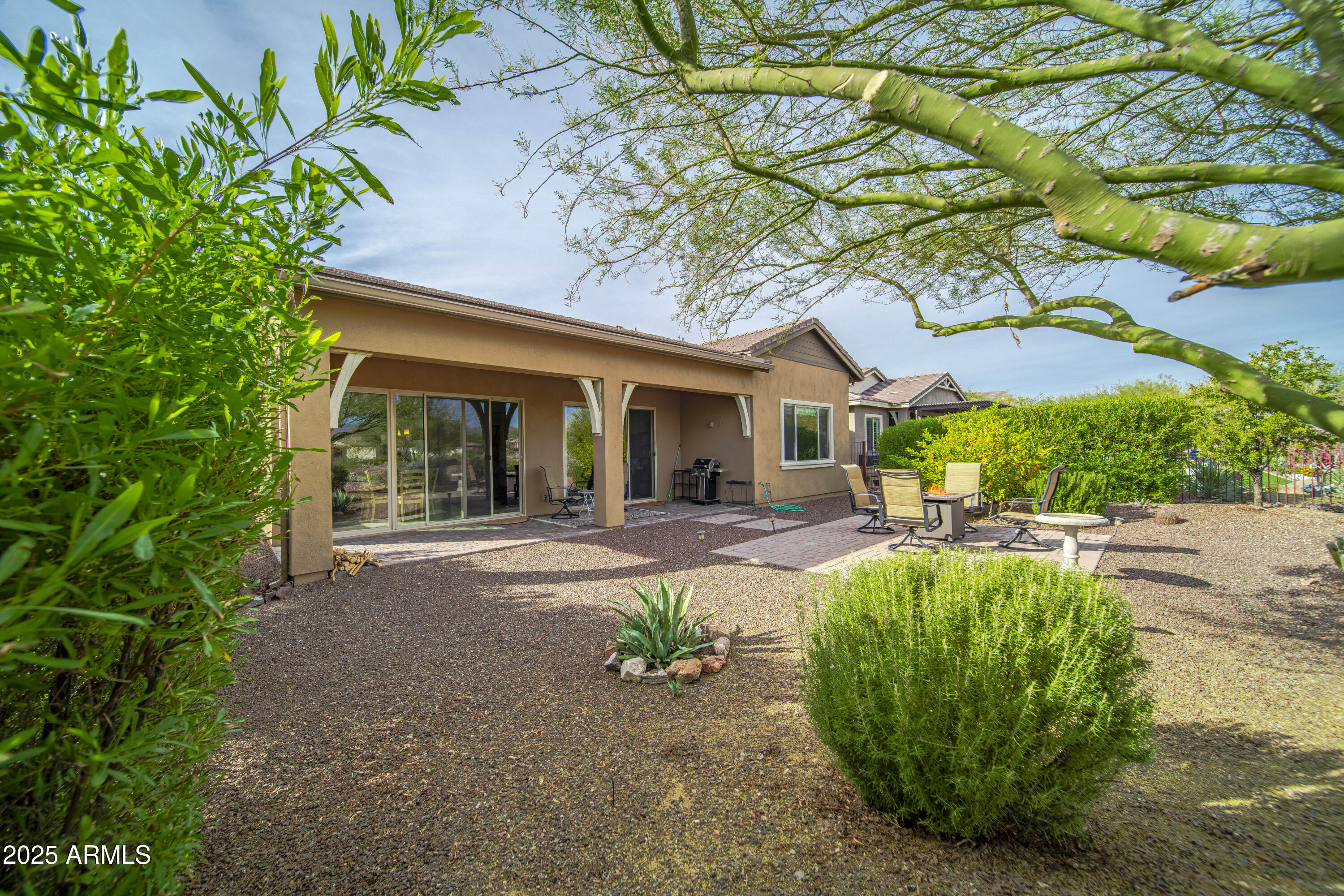 a view of a house with backyard porch and sitting area