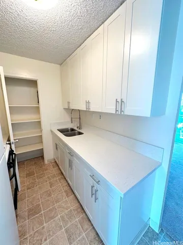 a kitchen with a cabinets and white appliances