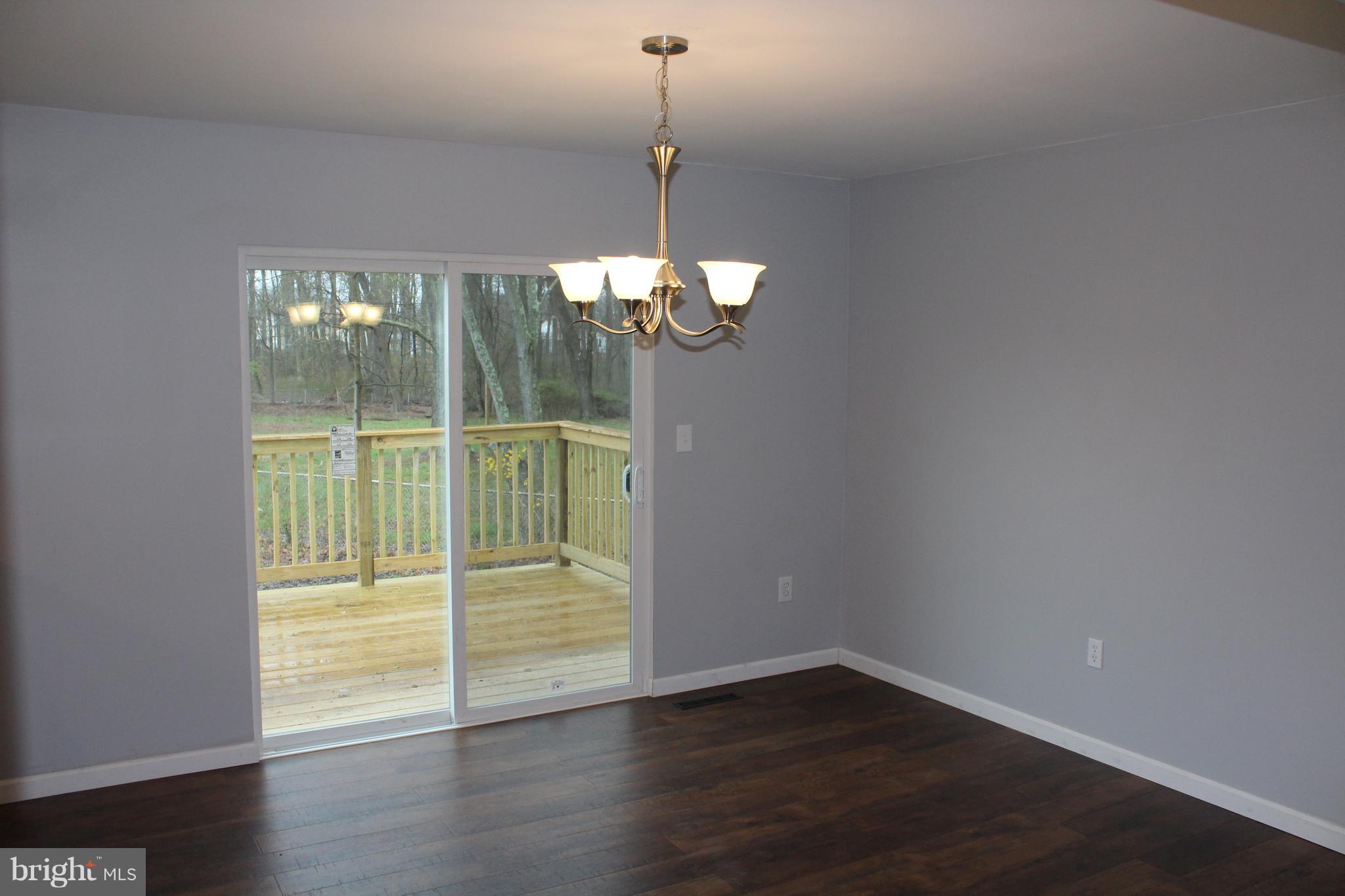 1106 Wampler Road Middle River, MD 21220 - Photo 12 of 27 a view of an empty room with wooden floor and a window