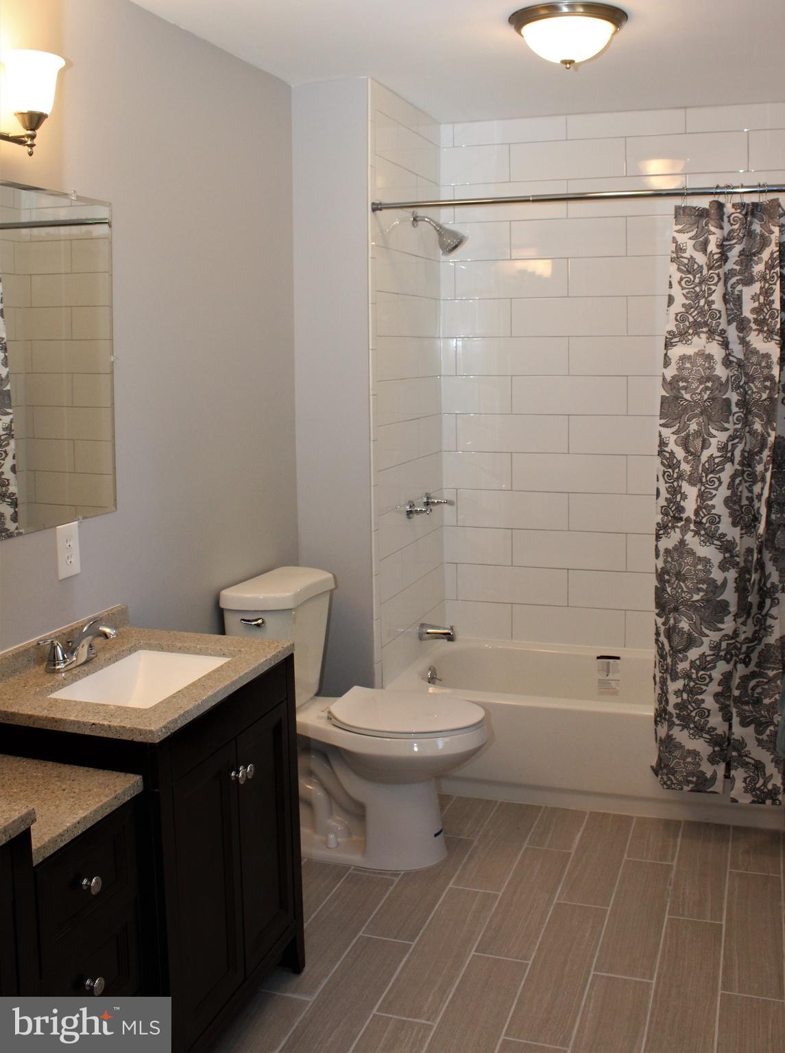 1106 Wampler Road Middle River, MD 21220 - Photo 19 of 27 a bathroom with a sink a toilet and shower