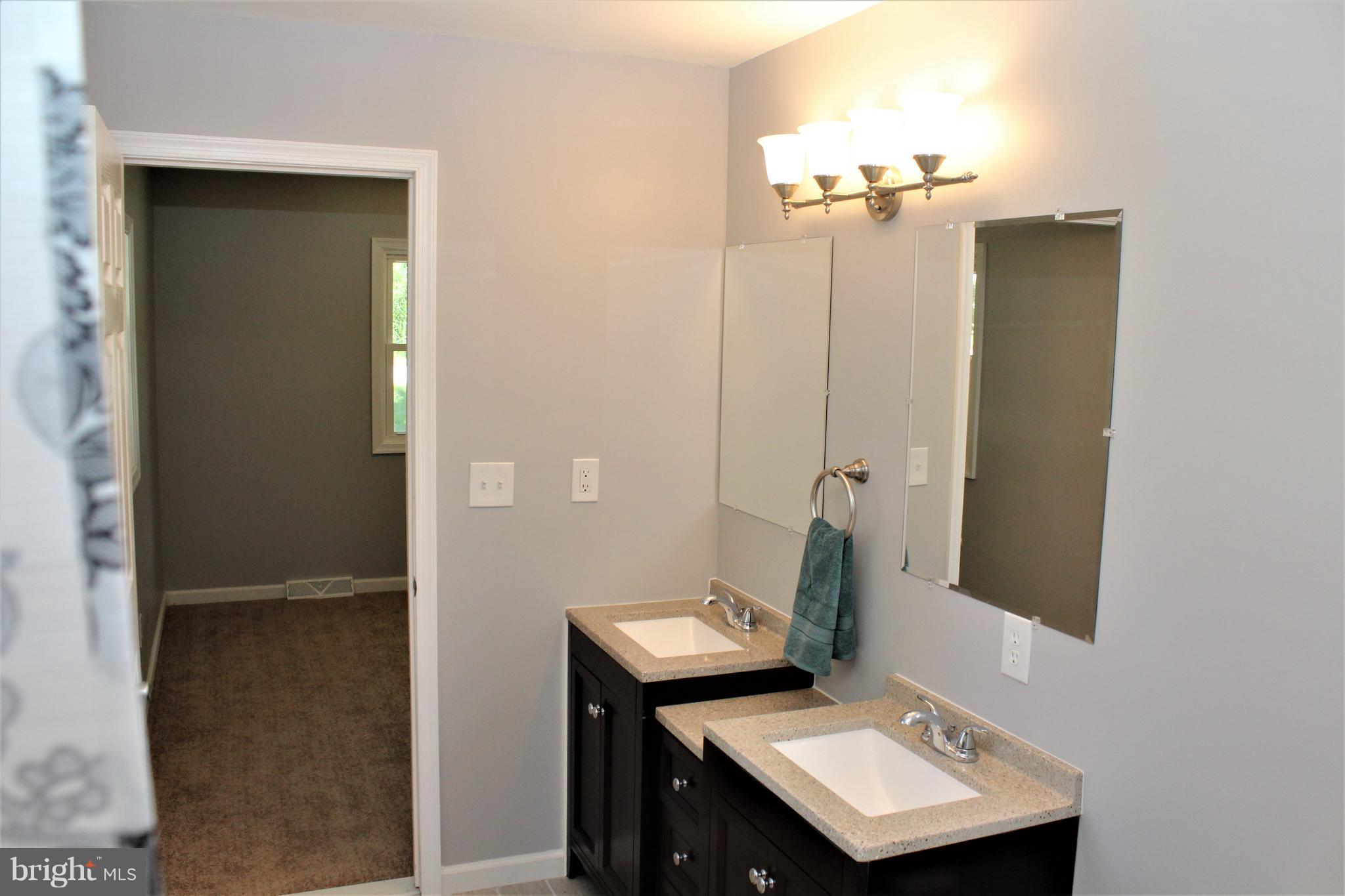 1106 Wampler Road Middle River, MD 21220 - Photo 20 of 27 a bathroom with a sink a toilet and mirror