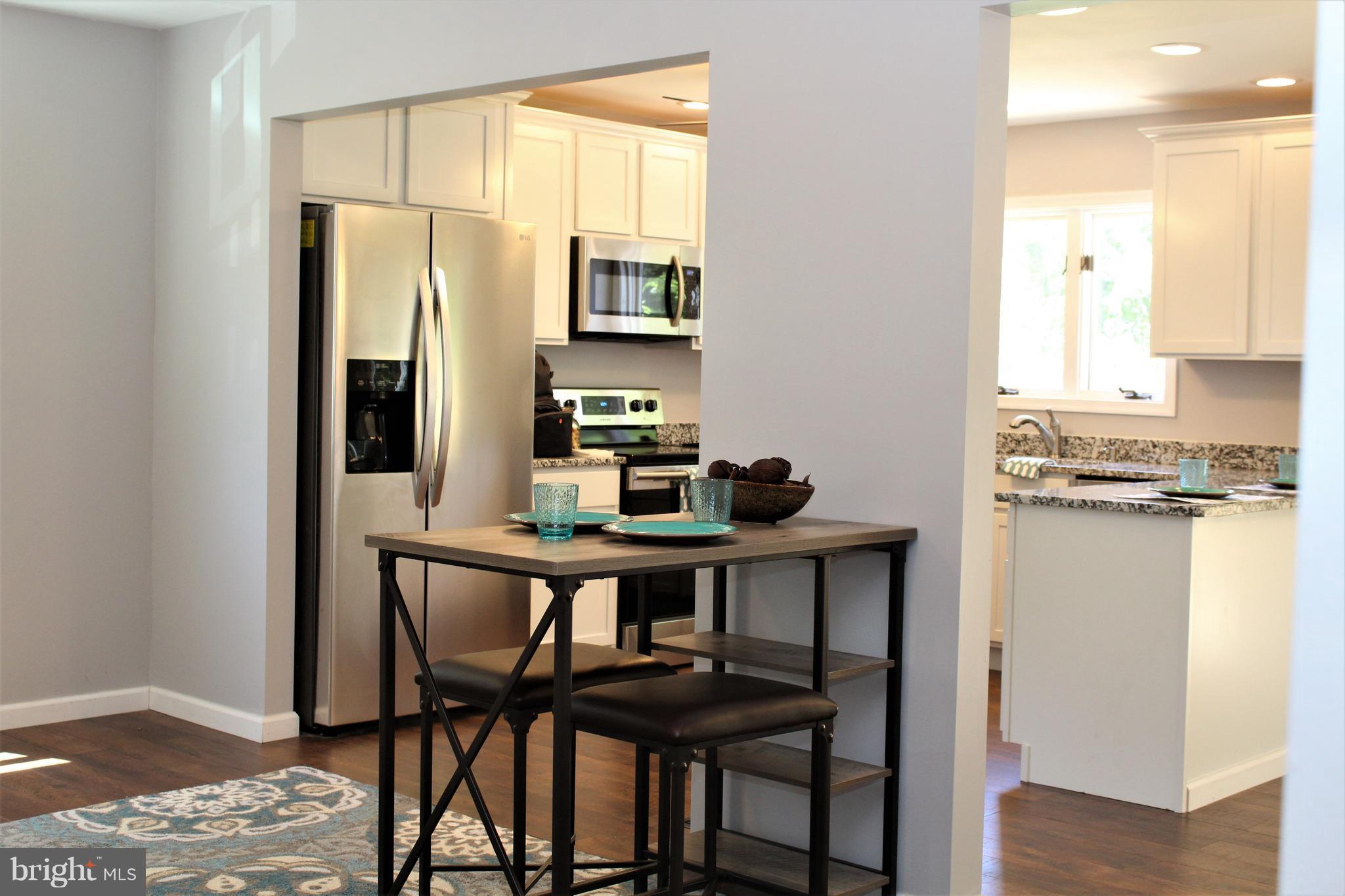 1106 Wampler Road Middle River, MD 21220 - Photo 6 of 27 a view of a dining room with furniture and wooden floor