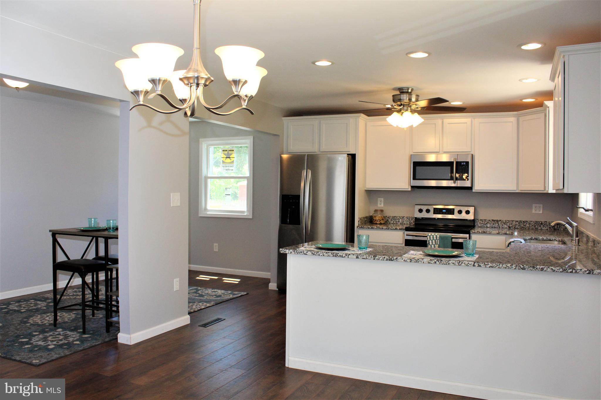 1106 Wampler Road Middle River, MD 21220 - Photo 10 of 27 a kitchen with stainless steel appliances a stove refrigerator and microwave