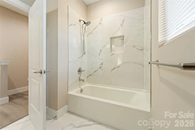 a bathroom with a bathtub and a shower