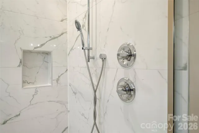 a bathroom with a table and a shower