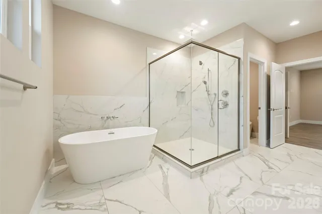 a bathroom with a bathtub and shower