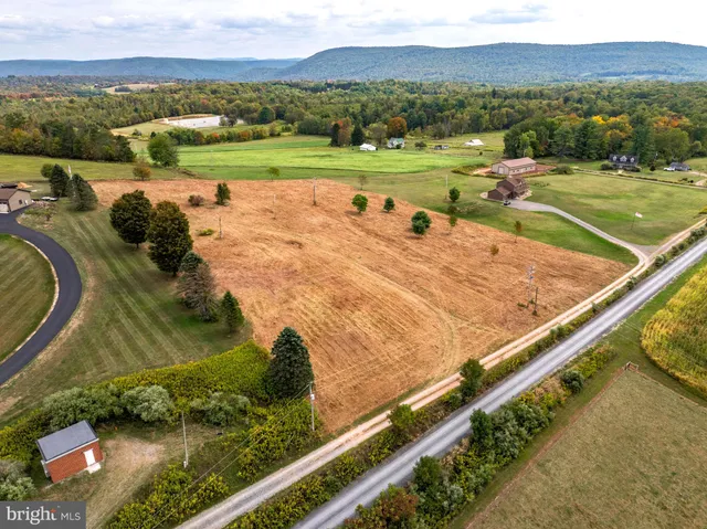 an aerial view of a house with a yard basket ball court and outdoor seating