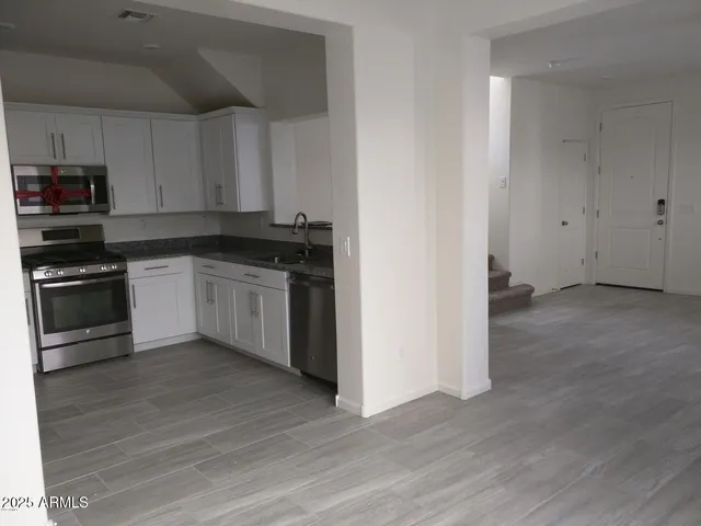 a kitchen with granite countertop a stove and a sink
