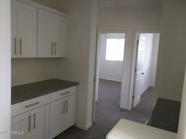 a kitchen with white cabinets