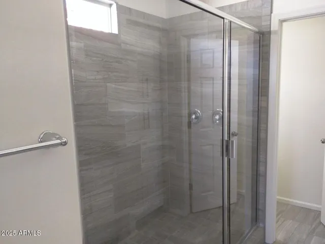 a bathroom with a glass shower door