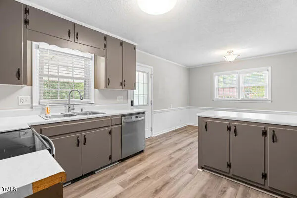 a kitchen with granite countertop a refrigerator stove and sink