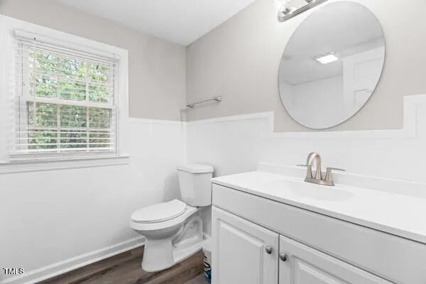 a bathroom with a toilet a sink and a mirror