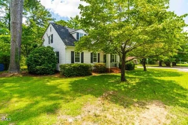 a front view of a house with garden and patio