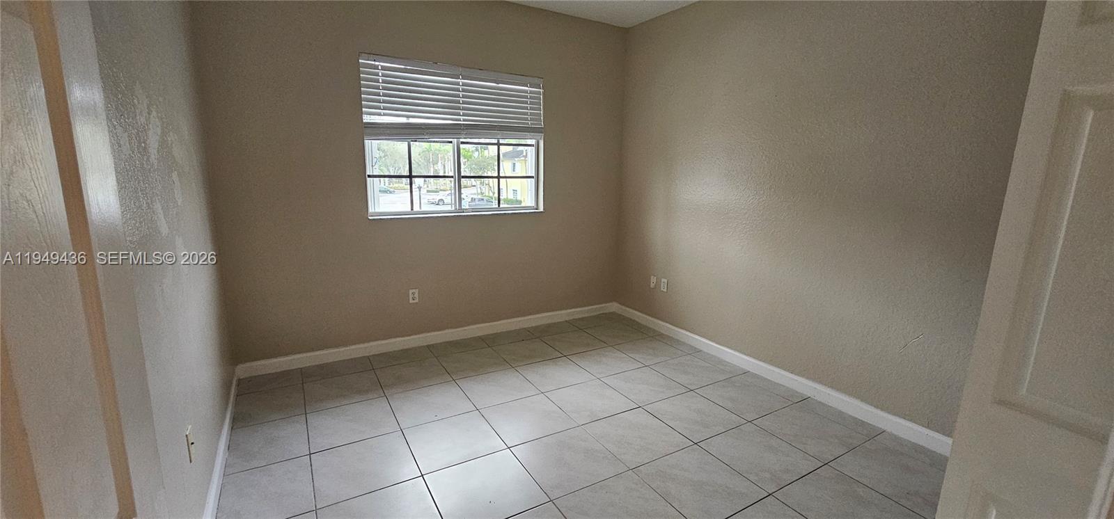 2711 Northeast 4th Street, Unit 204 Homestead, FL 33033 - Photo 11 of 13 a view of an empty room with a window