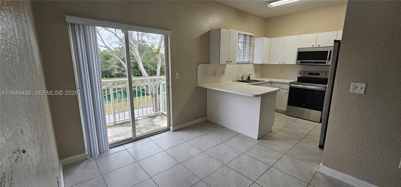 2711 Northeast 4th Street, Unit 204 Homestead, FL 33033 - Photo 7 of 13 a kitchen with stainless steel appliances granite countertop a stove a sink and a refrigerator