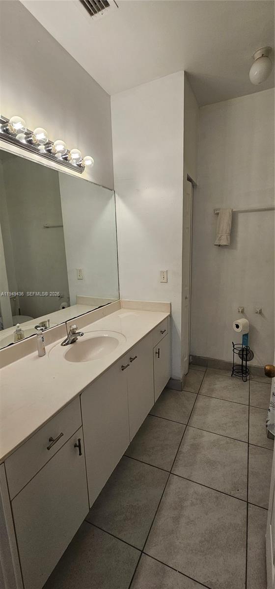 2711 Northeast 4th Street, Unit 204 Homestead, FL 33033 - Photo 9 of 13 a bathroom with a double vanity sink and a mirror