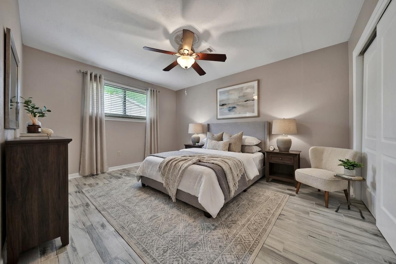2006 Mermaid Lane Houston, TX 77062 - Photo 20 of 35 a spacious bedroom with a bed and a chandelier