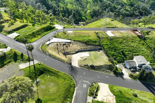 an aerial view of a house with a yard basket ball court and outdoor seating