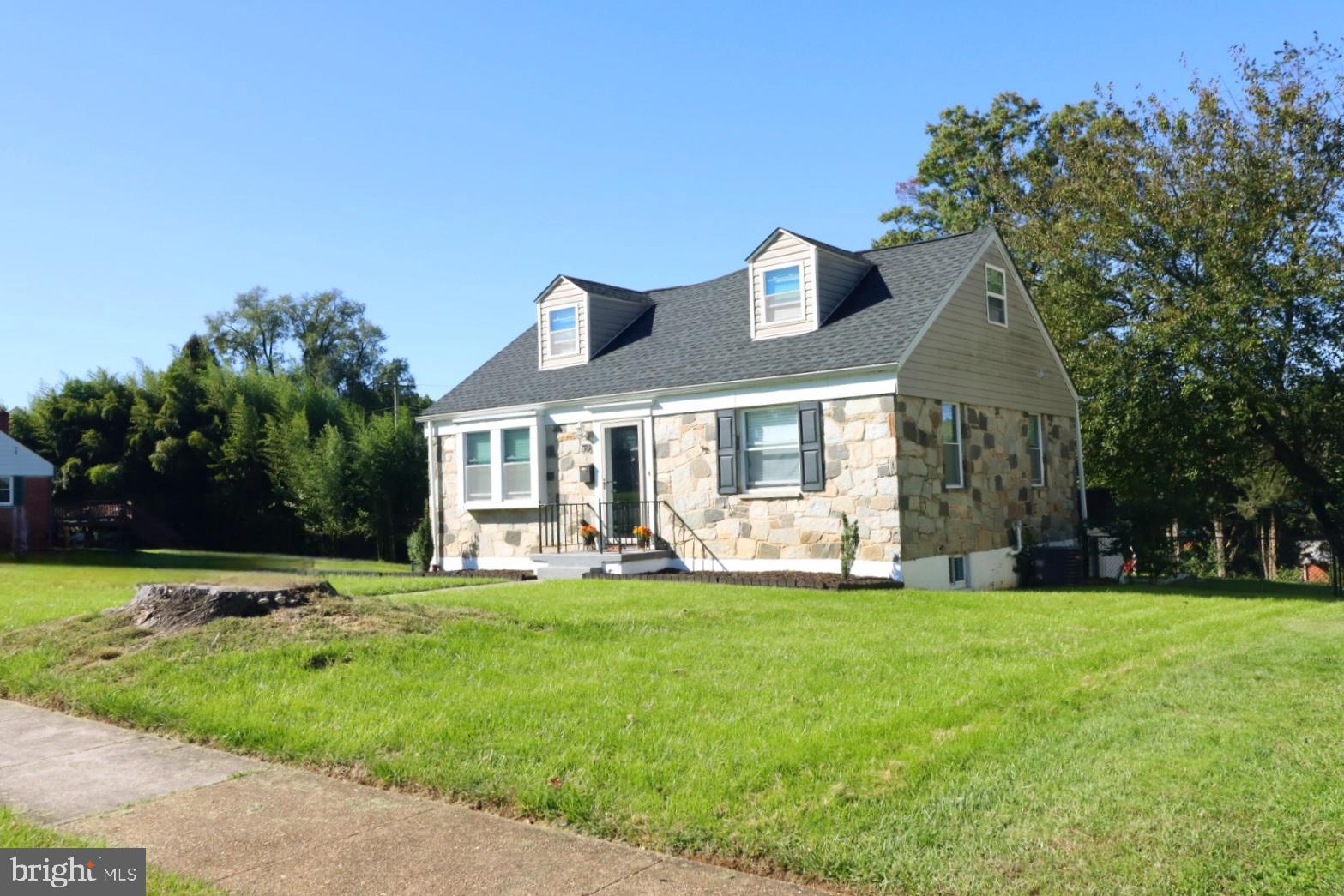 718 Cliffedge Road Pikesville, MD 21208 - Photo 2 of 28 a front view of a house with a big yard and potted plants