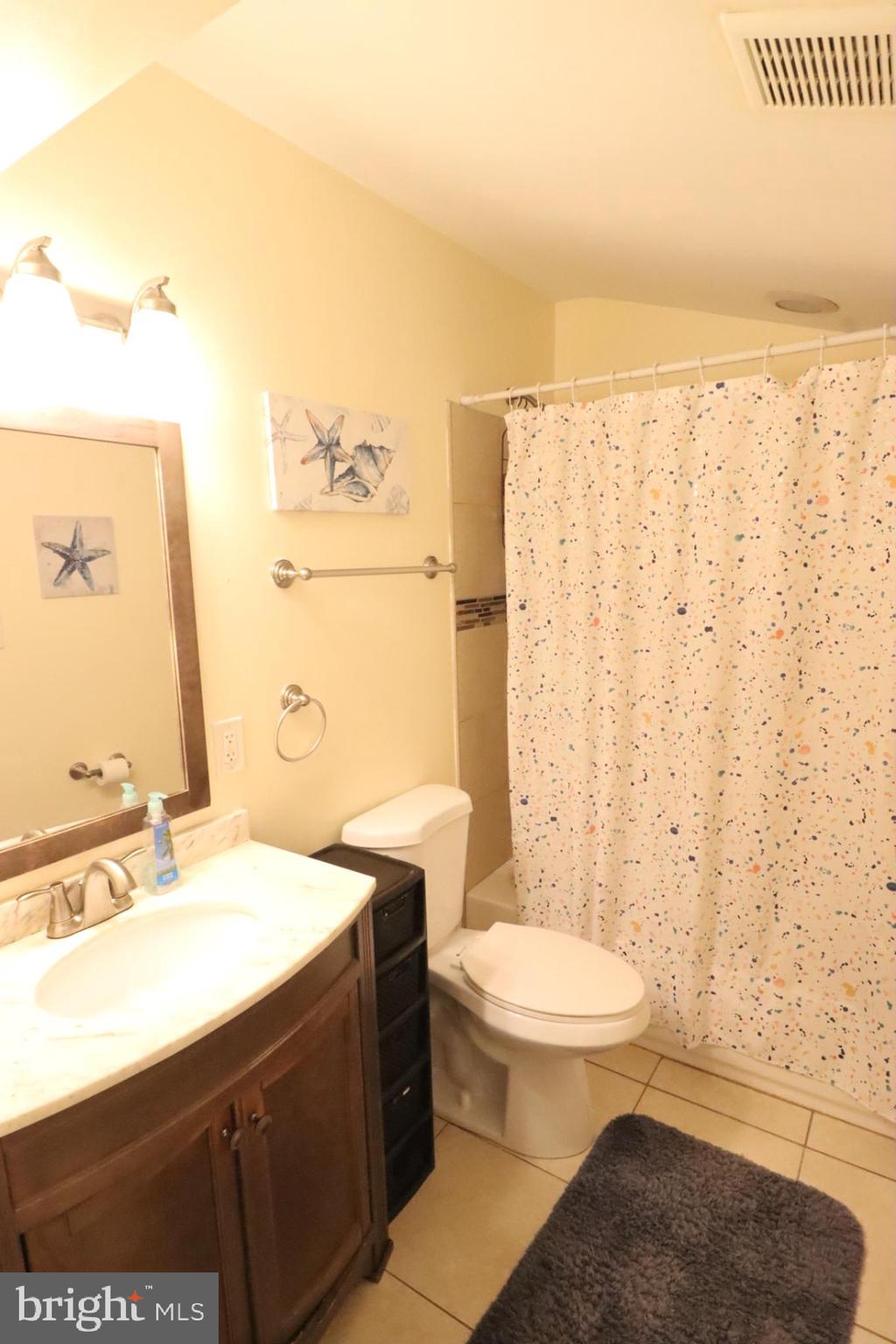 718 Cliffedge Road Pikesville, MD 21208 - Photo 22 of 28 a bathroom with a sink a toilet and shower