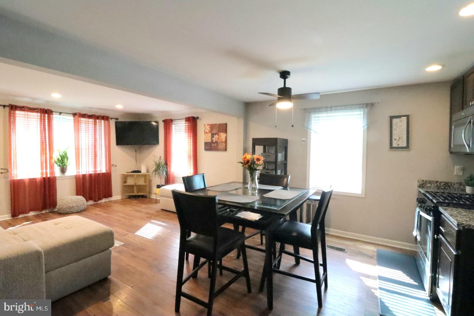 718 Cliffedge Road Pikesville, MD 21208 - Photo 9 of 28 a view of a dining room with furniture and wooden floor