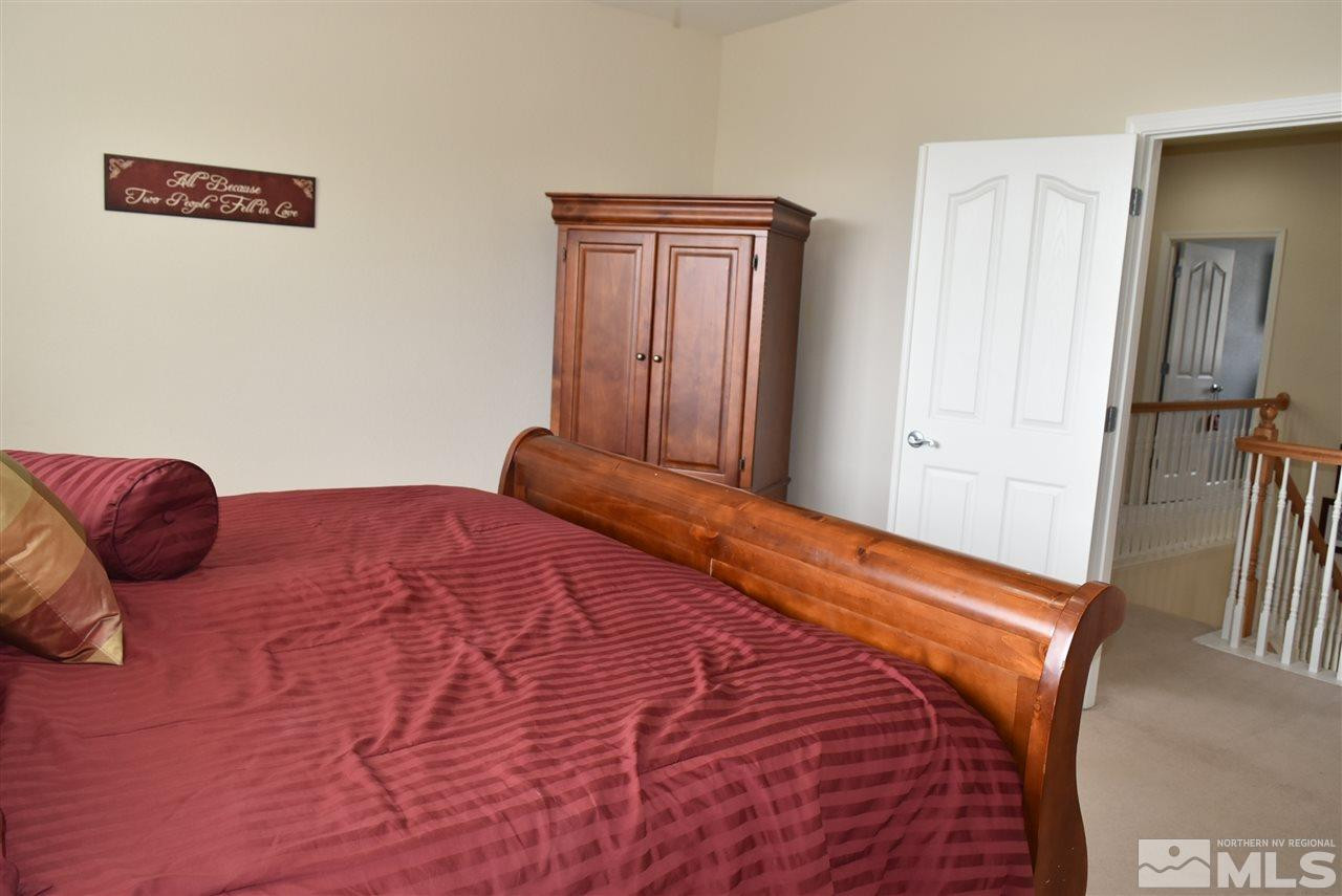 10675 Cedar Bend Court Reno, NV 89521 - Photo 11 of 22 a bedroom with a bed and wooden floor