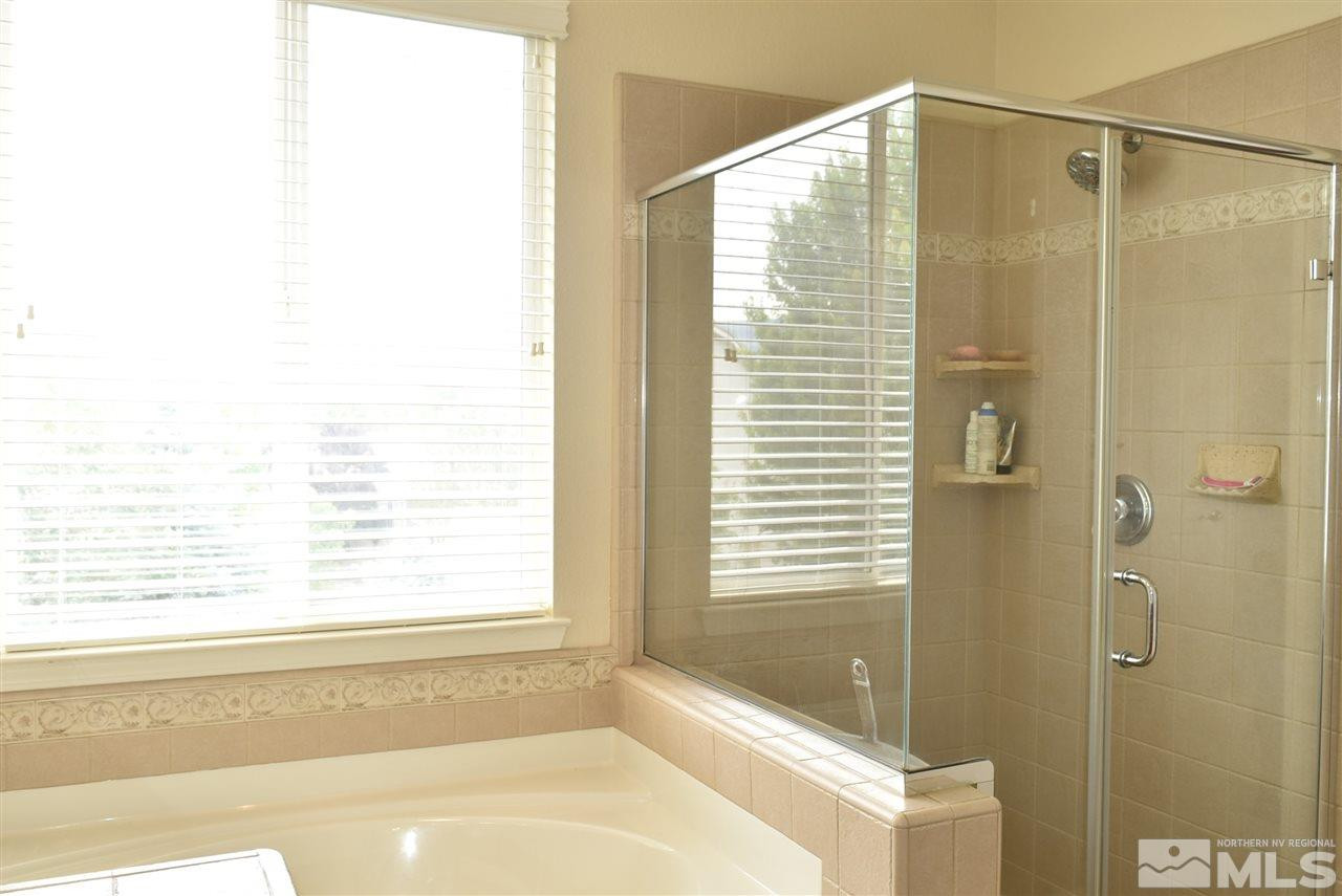 10675 Cedar Bend Court Reno, NV 89521 - Photo 13 of 22 a bathroom with a bathtub and shower