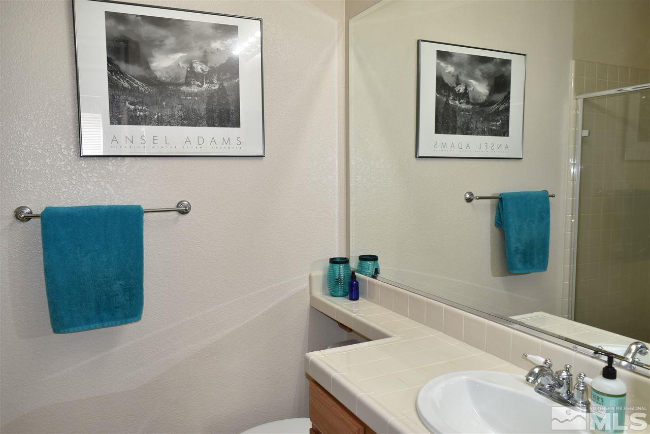 10675 Cedar Bend Court Reno, NV 89521 - Photo 17 of 22 a bathroom with a sink and a mirror