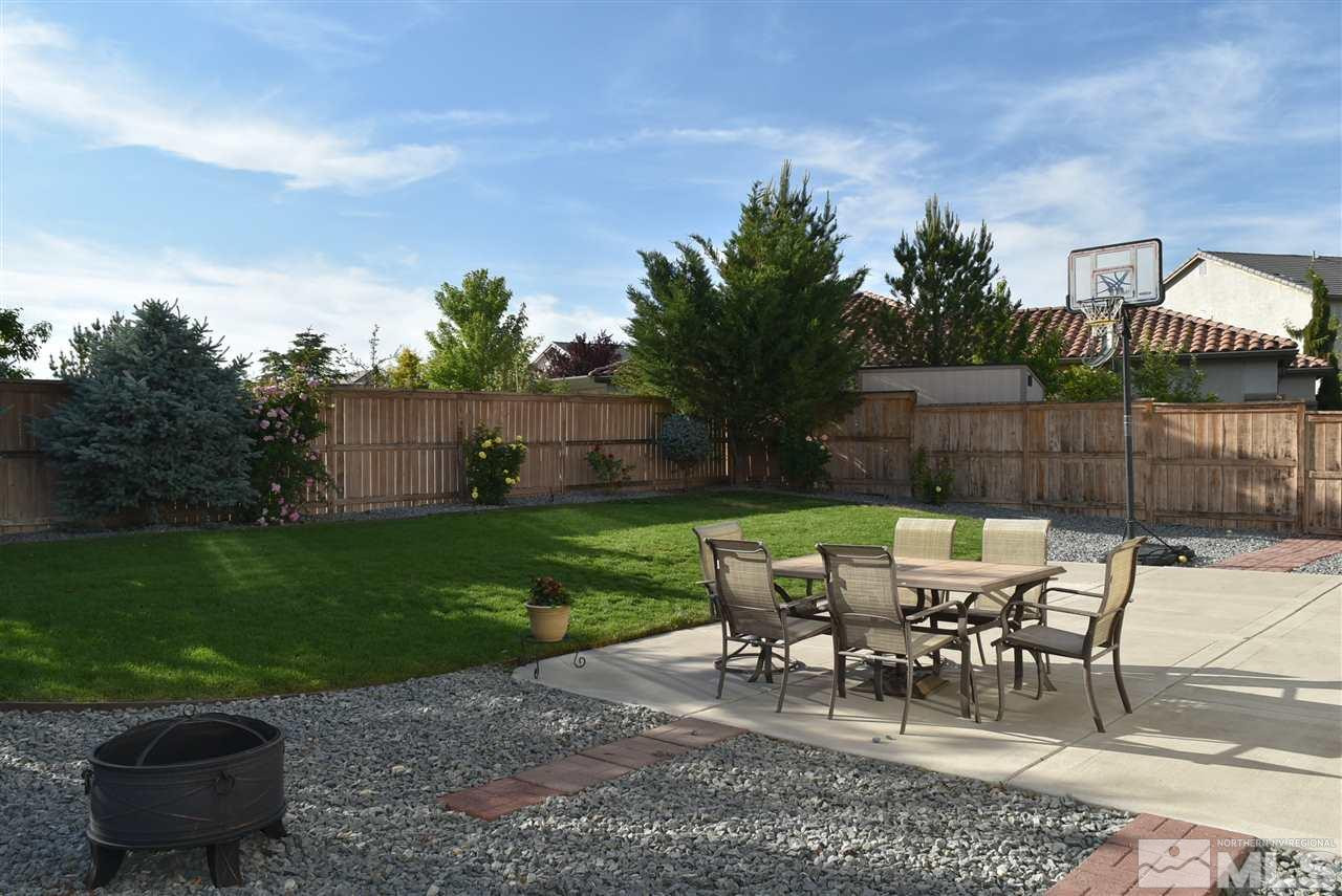 10675 Cedar Bend Court Reno, NV 89521 - Photo 22 of 22 a view of a chairs and table in backyard