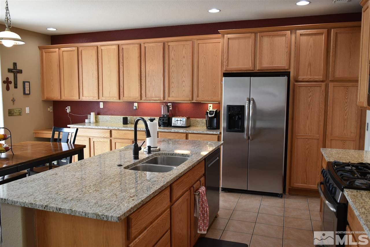 10675 Cedar Bend Court Reno, NV 89521 - Photo 6 of 22 a kitchen with stainless steel appliances granite countertop a refrigerator a sink and a stove